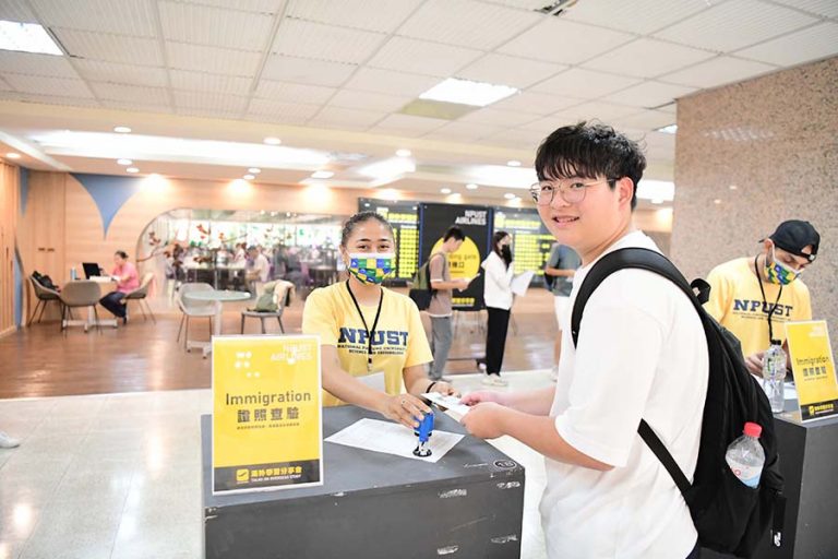 foreigner student being immigration officer check the departure information for Taiwanese student