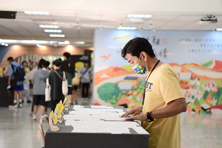 foreigner student being ground staff is searching the boarding pass for check-in